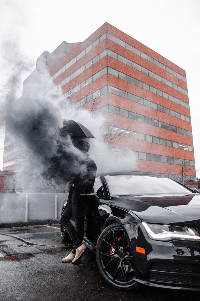 Stylish luxury car with smoke effect in urban Portland setting reflecting modern design.